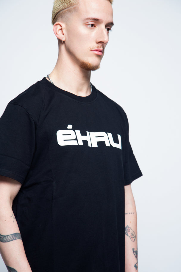 Person wearing a black t-shirt with 'ÉHRU' logo on a white background
